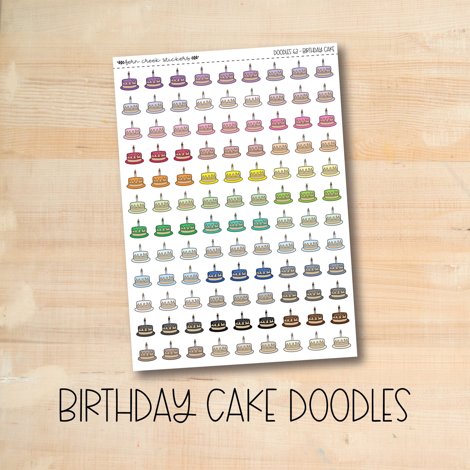 a birthday cake doodles sticker on a wooden table