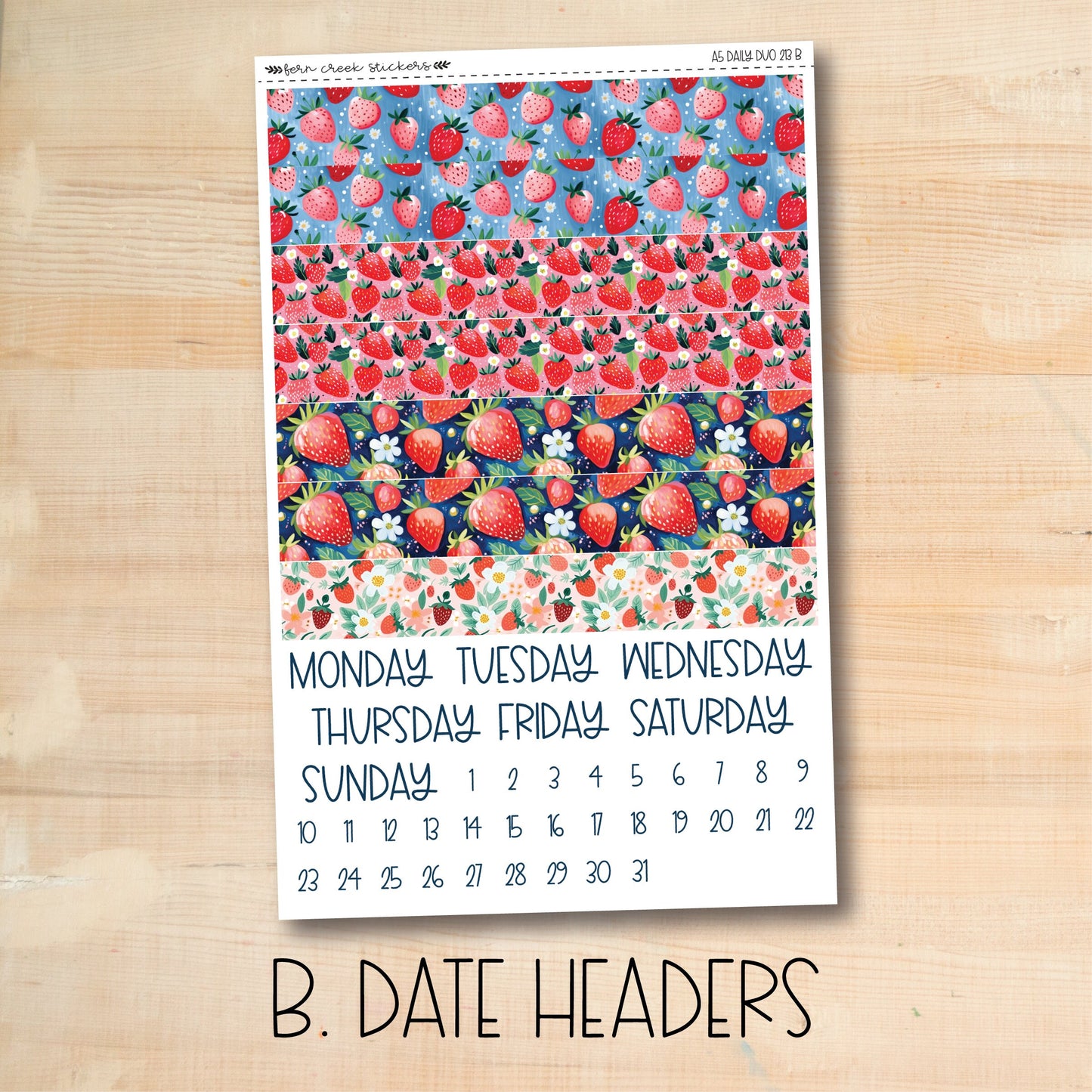 a calendar with strawberries on a wooden table
