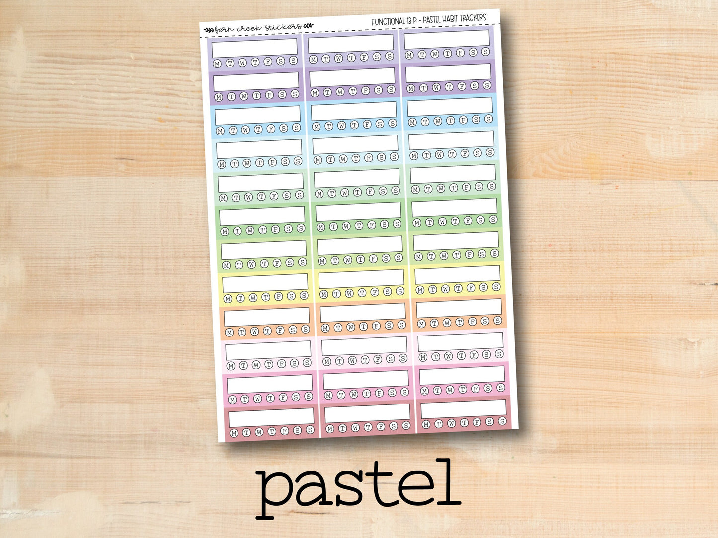 a pastel planner sticker on a wooden surface