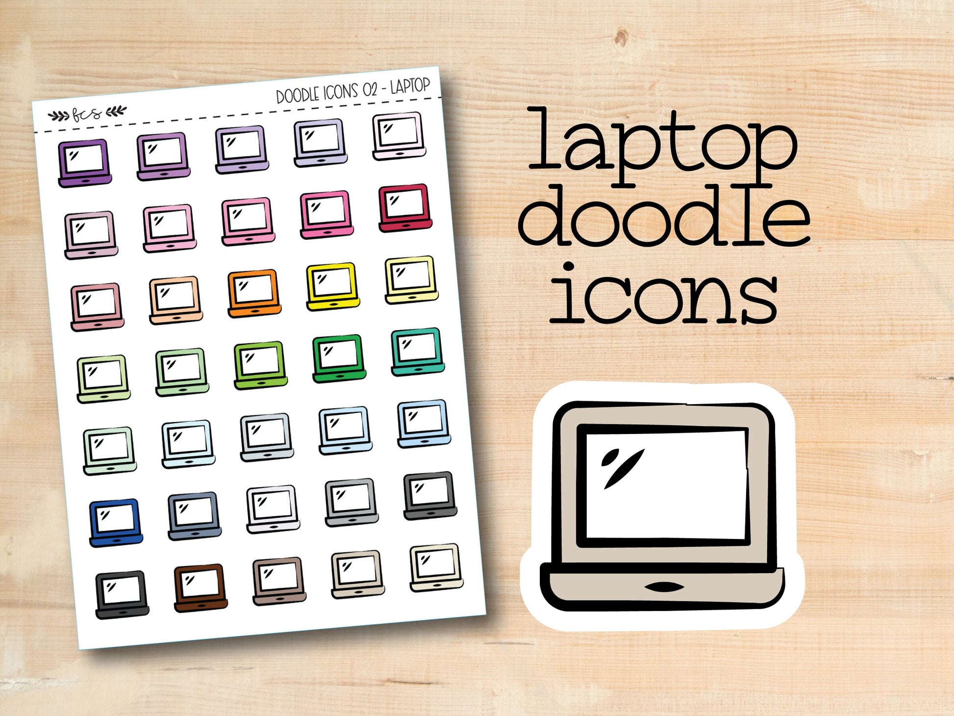 laptop doodle icons stickers on a wooden surface