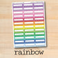 a rainbow sticker on a wooden surface