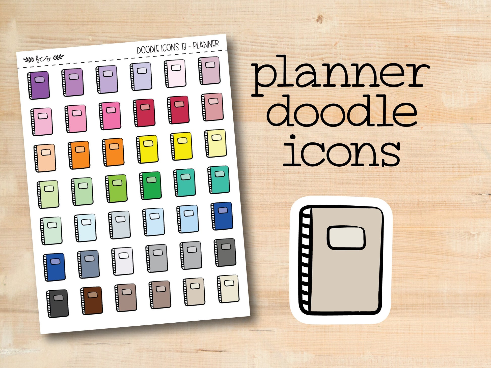 a planner doodle icons sticker next to a wooden background