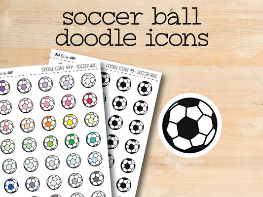 a pair of soccer ball doodle icons on a wooden surface