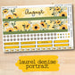 a yellow floral planner sticker on a wooden surface