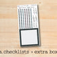 a checklist and extra box on a wooden surface