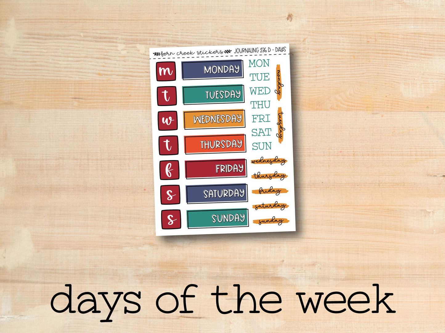 the days of the week sticker is displayed on a wooden surface