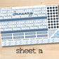 a blue and white planner sticker sitting on top of a wooden table