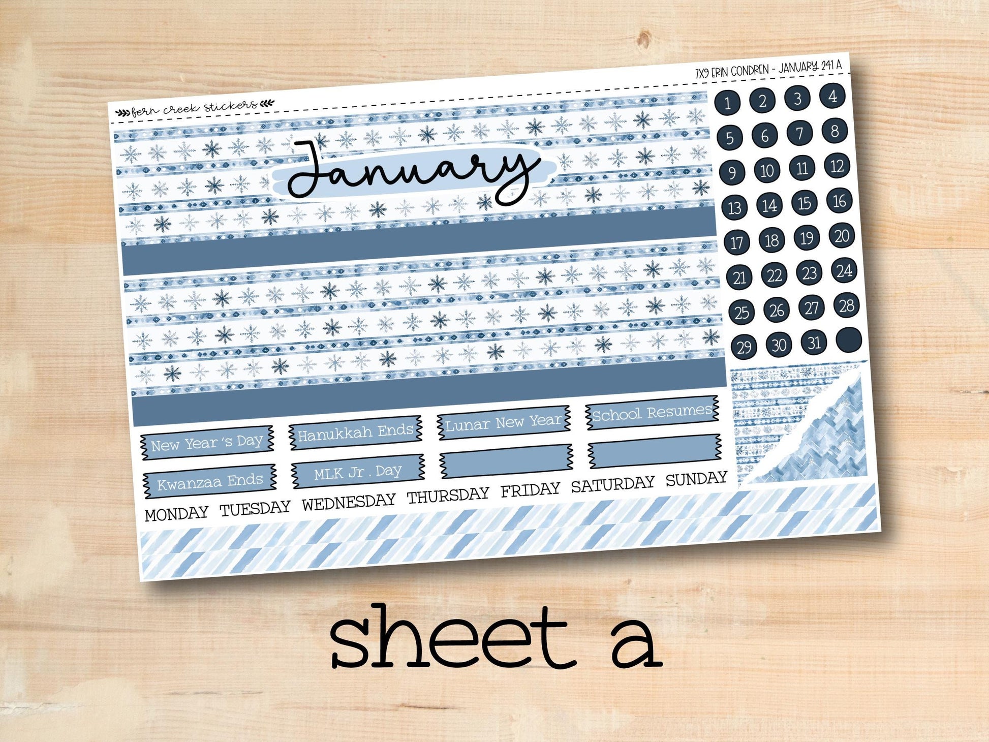 a blue and white planner sticker sitting on top of a wooden table