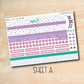 a pink and green planner sticker on a wooden surface