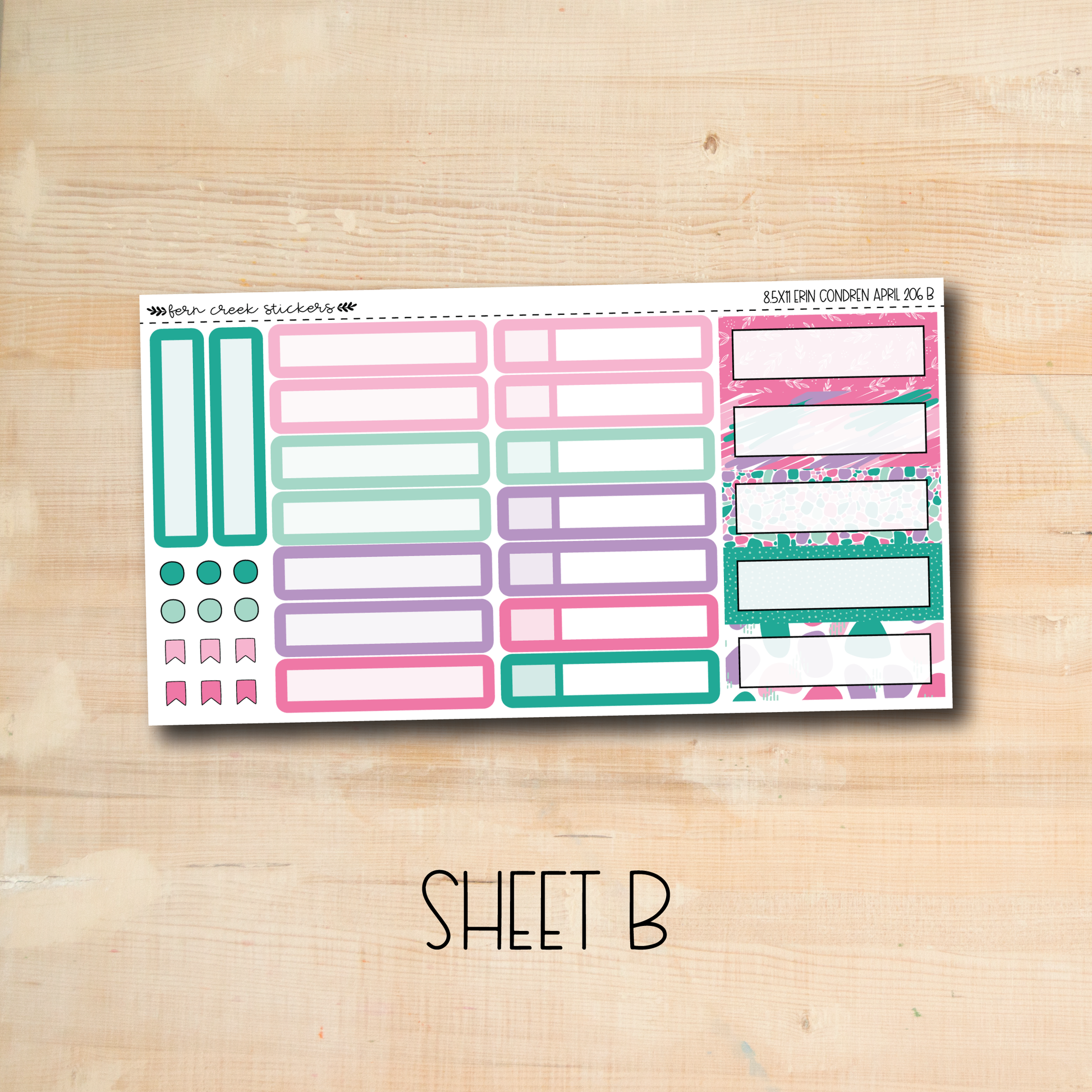 a pink and green planner sticker sitting on top of a wooden table