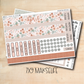 a pair of planner stickers on a wooden surface