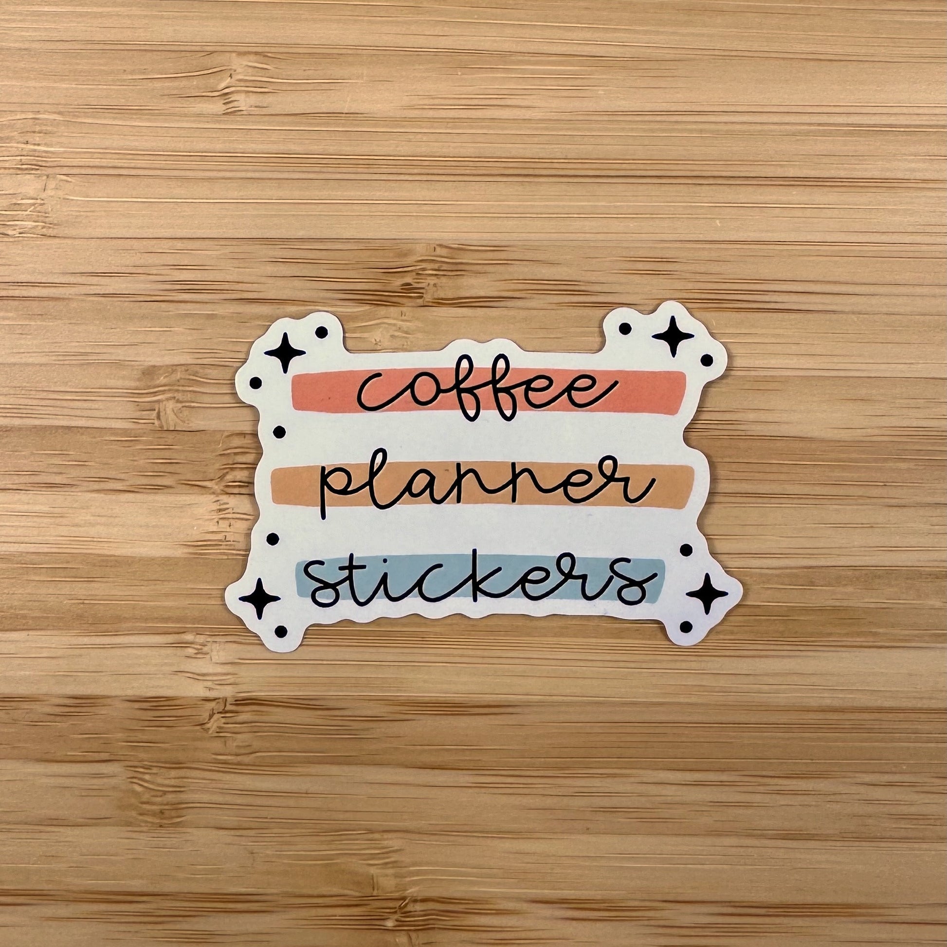 a sticker that says coffee planner stickers on a wooden surface
