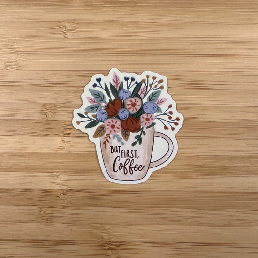 a sticker of a coffee cup with flowers on it