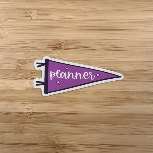 a sticker that says planner on a wooden surface
