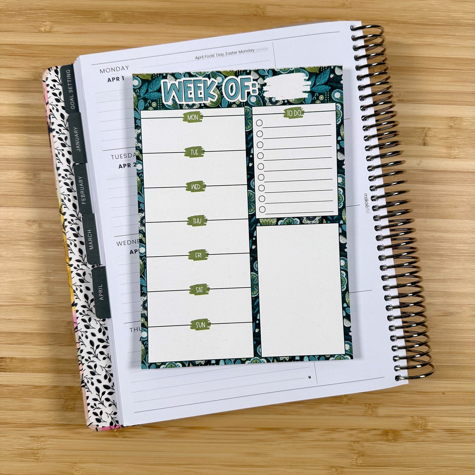 a notebook with a planner on top of it