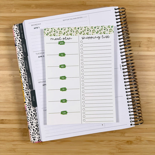 a notebook with a planner on top of it