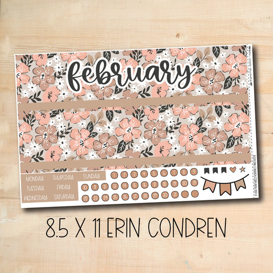 a wooden table topped with a calendar and flowers