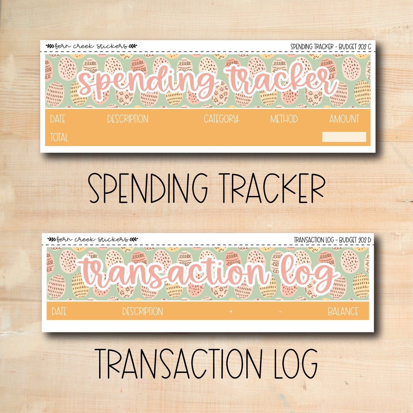 a wooden table with two stickers that say spending trackerr and transaction log