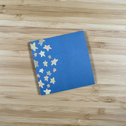 a blue notebook with gold stars on it