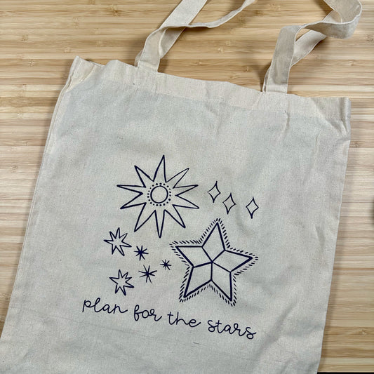 a tote bag that says plan for the stars