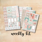 three planner stickers on a wooden surface